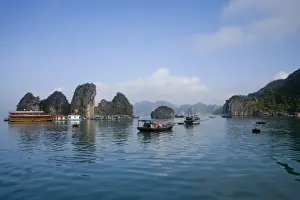 Floating Vietnamese fishing village with rocky coastline
