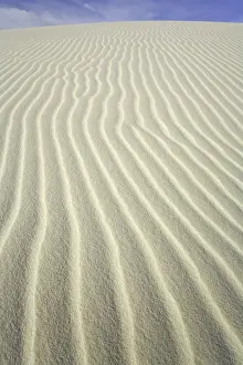 Flowing patterns and shapes created by wind on white gypsum sand dunes