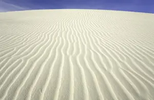 Flowing patterns and shapes created by wind on white gypsum sand dunes