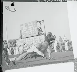 Football Player Breaking Free from Tackle