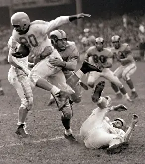 Tackling Prints: Football Player Leaping Through Air