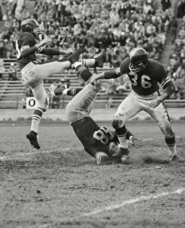 Football Players in Awkward Positions During Game