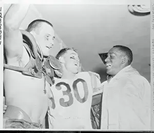 Football Players Celebrating in Dressing Room