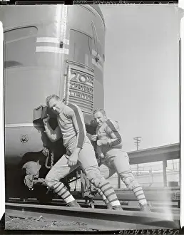 Football Players Pushing Railroad Car