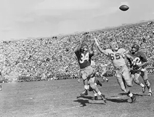 Football Players Reaching for the Ball