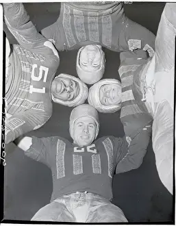 Football Players Standing in Huddle