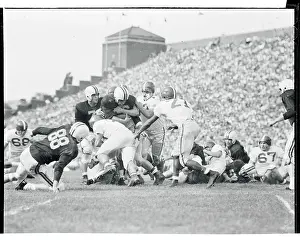 Football Players Tackling John Baumgartner