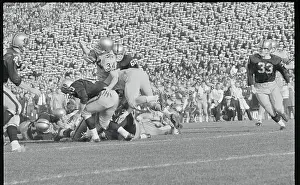 Football Players Tackling Their Opponent
