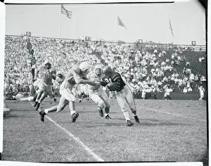 Football Players Tackling an Opponent