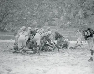 Football Players Tackling Their Opponents