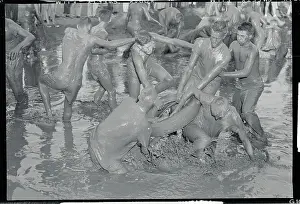 Football Players Wrestling in Mud