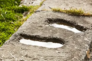 Delphi Prints: Footprints in a stone wall filled with water