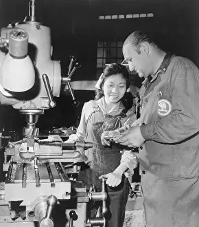Foreman Instructing Vietnamese Woman