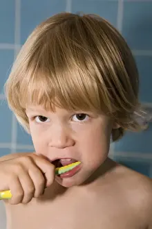 Tooth Prints: Four-year-old blond boy brushing his teeth