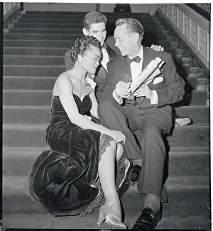 Prints of (Original Caption). Franchot Tone (right) shows one of the rave notices given to the new play, New Faces of 1952, to Eartha Kitt (left) and Ronny Graham, stars of the show Captivating Art Prints Celebrating the Iconic Performer’s Legacy: Franchot Tone, Eartha Kitt, and Ronny Graham Sitting Together on the Steps