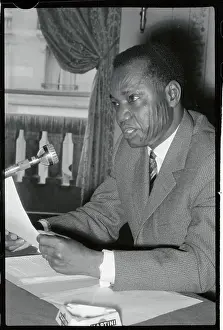 Francois Tombalbaye Holding a Document at News Conference
