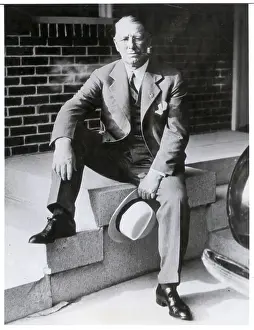 Candidate Prints: Frank Knox Seated on Steps Smoking Pipe