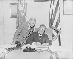 Franklin D. Roosevelt in His Office with William Woodin Observing