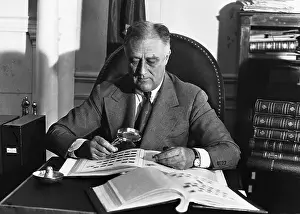 Prints of Franklin Delano Roosevelt looks at his stamp collection to distract his attention from the immense pressure which has just erupted as a result of the attack on Pearl Harbor Pearl Harbor Prints: Franklin Delano Roosevelt Looking at His Stamp Collection