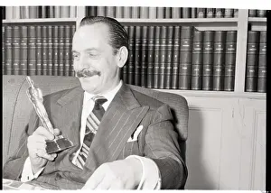 Candidate Prints: Frederick March Holds Cardboard Oscar