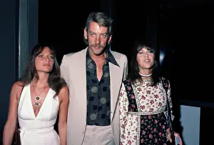 Prints of British actress Jacqueline Bisset, wearing a white v-neck dress, Canadian actor Donald Sutherland, who wears a beige suit, and American actress Jane Fonda, in a floral pattern dress Vietnam War Prints: Free The Army Event, August 1972