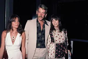Prints of British actress Jacqueline Bisset, wearing a white v-neck dress, Canadian actor Donald Sutherland, who wears a beige suit, and American actress Jane Fonda, in a floral pattern dress Vietnam War Prints: Free The Army Event, August 1972