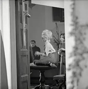 French Actress Brigitte Bardot Sitting on Table