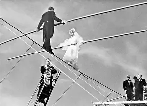 Tightrope Prints: French Bride and Groom on a High Wire with Attending Priest