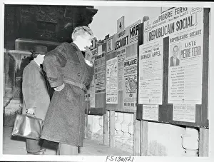 French Voter Reading Election Posters
