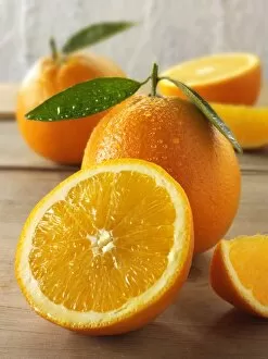 Fresh oranges, whole and half with leaves