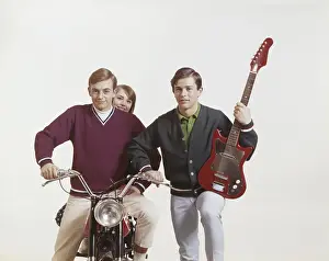 Jumper Prints: Friends with guitar and motorbike against white background, smiling, portrait
