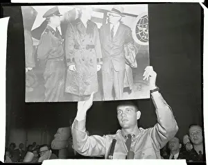 G. David Schine Holding up Large Picture Poster in Court