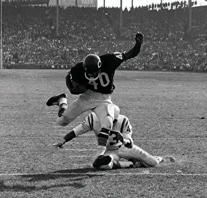 Agility Prints: Gale Sayers Eluding Tackle During Football Game