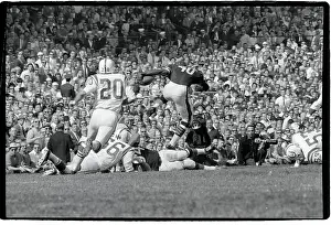 Gale Sayers Leaps Over Downed Players