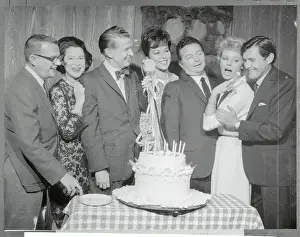 Game Show Stars Grouped Around Cake