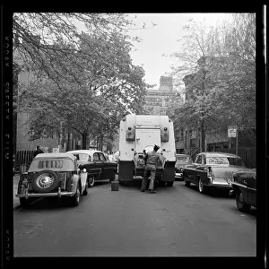 Prints of BROOKLYN, NY - MARCH 1958: A sanitation worker collects garbage in Brooklyn Heights, in March 1958 in New York City, New York. (Photo by David Attie/Getty Images) Portraits, Artworks, and Montages from a Visionary Photographer: Garbage Collection in 1950's Brooklyn Heights