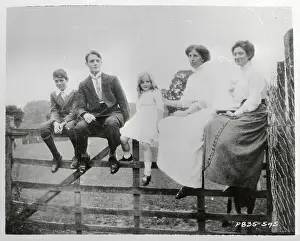 Gary Cooper with Family Sitting on Fence