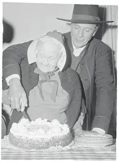Gary Cooper Helping Mary Carr Cut a Cake