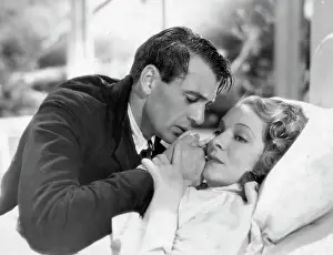 Henry Prints: Gary Cooper Leans Over Bed-Bound Helen Hayes