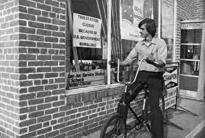 Gas Attendant Reading Sign at Station