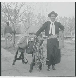 Gaucho Posing with Horse Saddle
