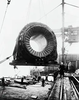 Laborer Prints: Generator Hoisted By Crane