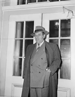 Generoso Pope Posing in Overcoat and Hat