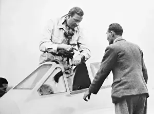 Cockpit Prints: Geoffrey de Havilland Climbing into Plane Cockpit