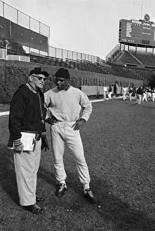 George Halas Talks to Gale Sayers on Football Field