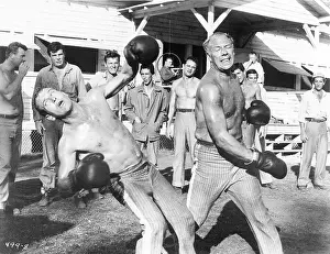 Prints of Actor George Kennedy sends actor Paul Newman sprawling in this scene from the hit movie, Cool Hand Luke Timeless Charm: A Visual Journey through the lens: George Kennedy Punching Paul Newman