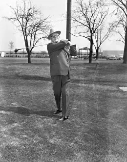 George May in Suit Swinging Golf Club