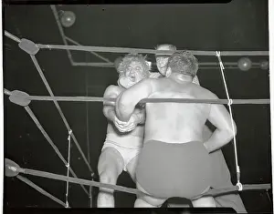 Prints of (Original Caption). Gorgeous George Wagner wrestles in exhibition match with Dusek Grappling Through Time: A Visual Journey of Wrestling History: George Wagner and Opponent Dusek in The Ring