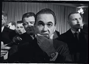 George Wallace Holding Chin in Thought