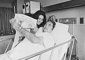 George Wallace Holding Newspaper with Wife in Hospital